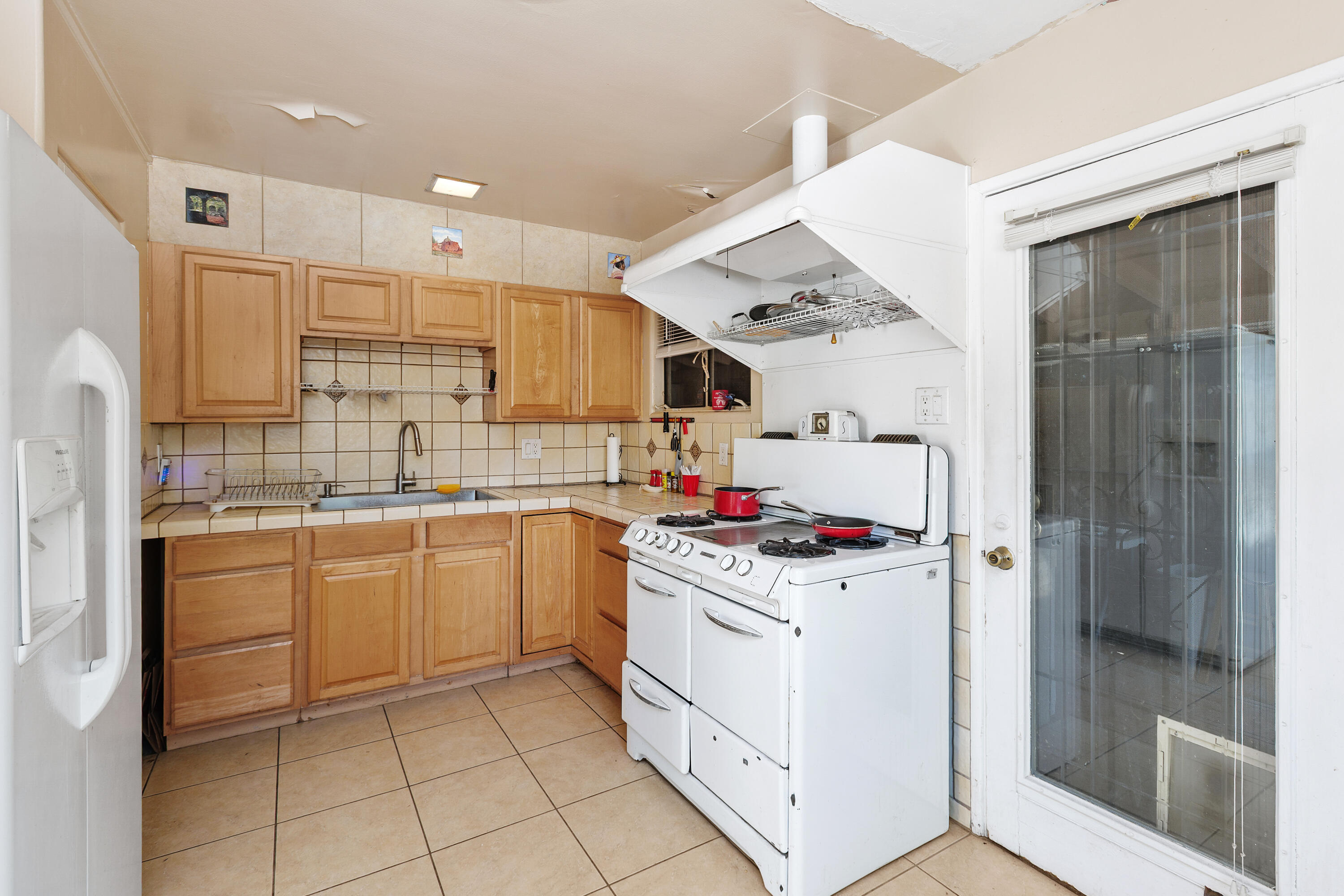 1077 South Riverside Drive Palm Springs, CA 92264 - Photo 17 of 35 a kitchen with a sink a stove and refrigerator