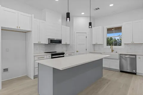 a kitchen with a sink stove and refrigerator