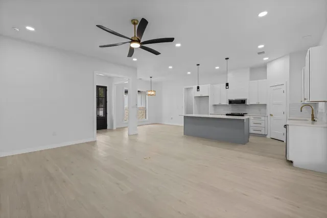 a view of a kitchen with a sink and a stove top oven