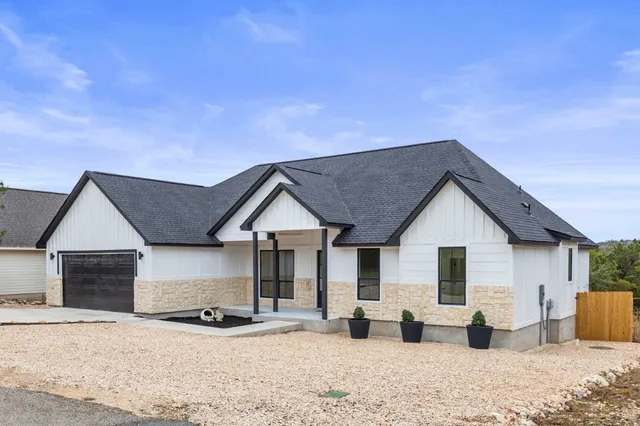 a view of a house with wooden roof and sitting space