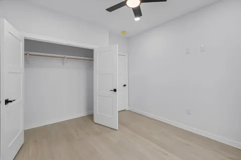a view of a porch with wooden floor and iron stairs