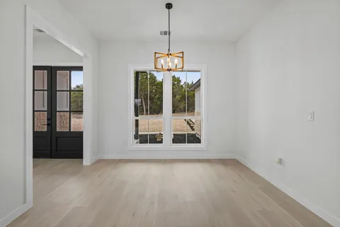 an empty room with windows and entrance