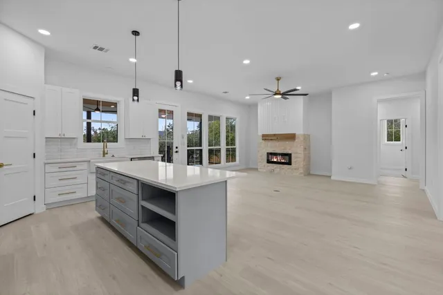 a kitchen with stainless steel appliances granite countertop a stove and cabinets