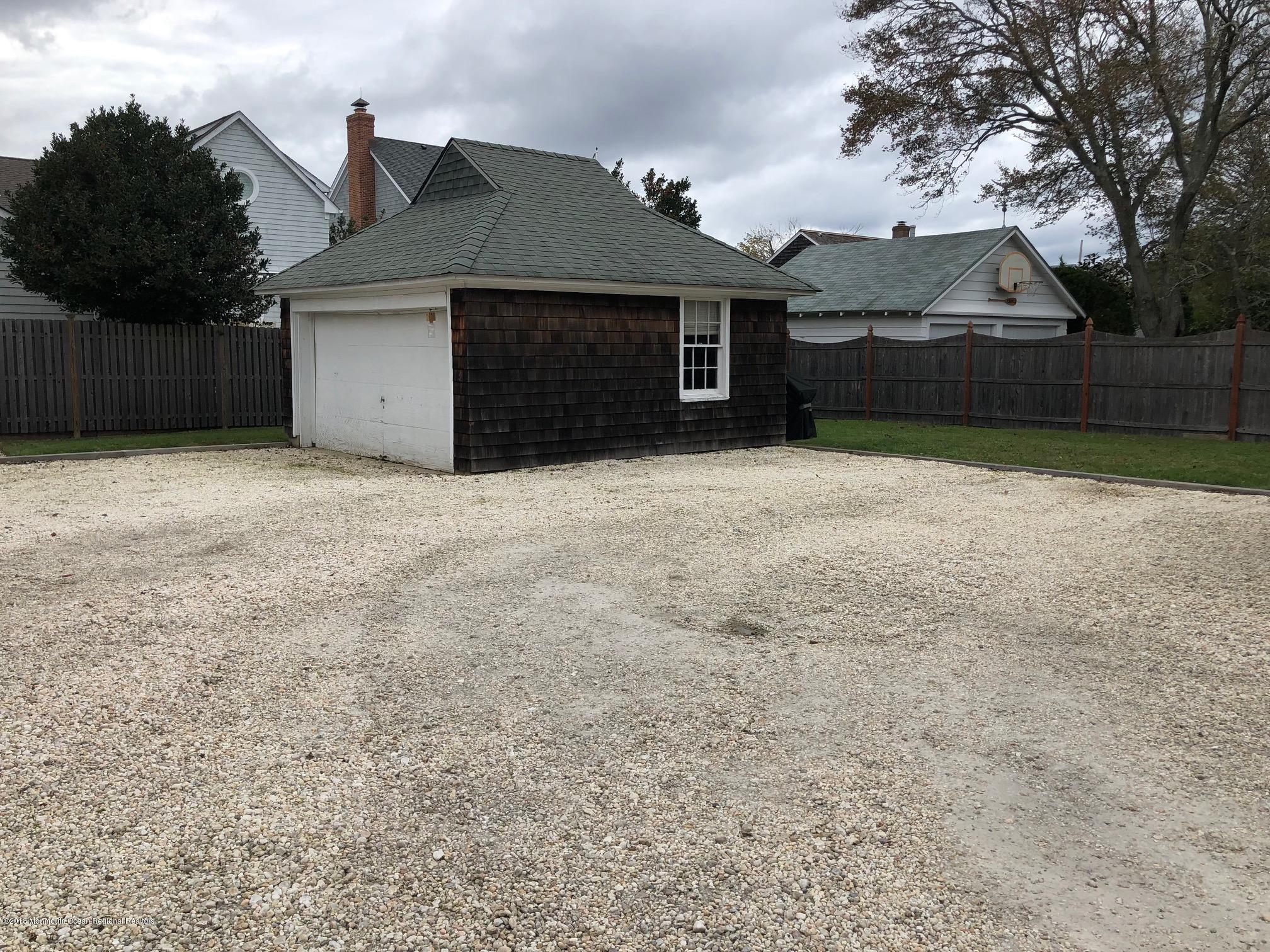 632 Main Avenue, Unit 1 Bay Head, NJ 08742 - Photo 13 of 16 a front view of a house with a yard and garage