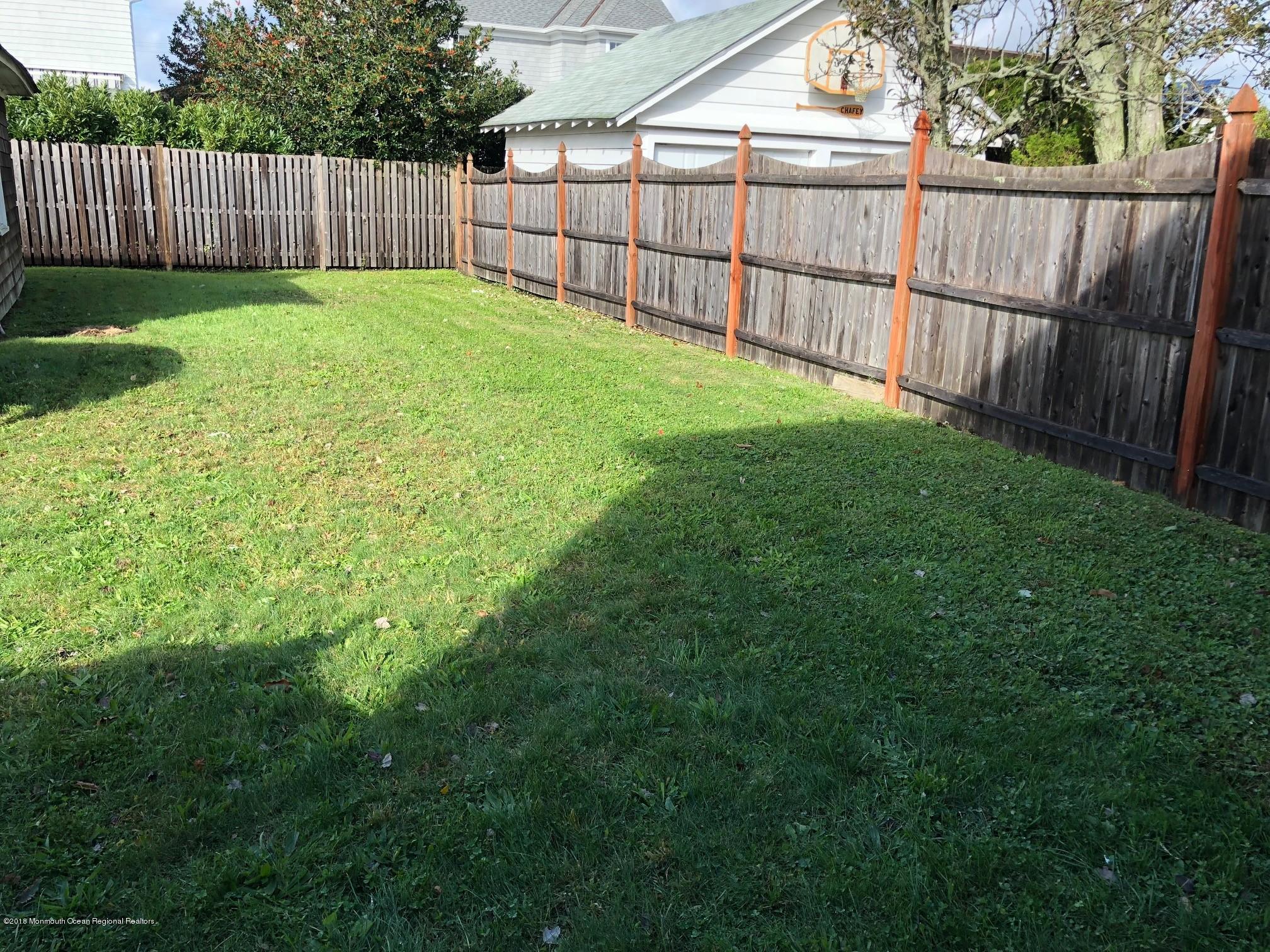 632 Main Avenue, Unit 1 Bay Head, NJ 08742 - Photo 14 of 16 a view of a backyard with a fence and wooden fence