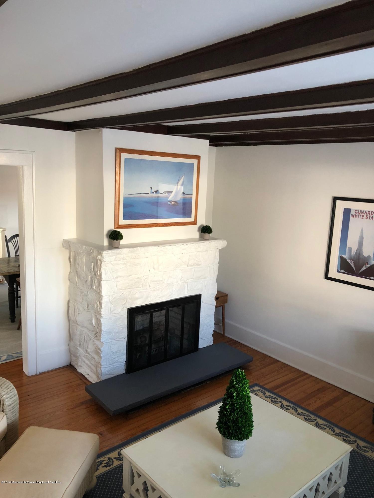 632 Main Avenue, Unit 1 Bay Head, NJ 08742 - Photo 3 of 16 a living room with furniture and a fireplace