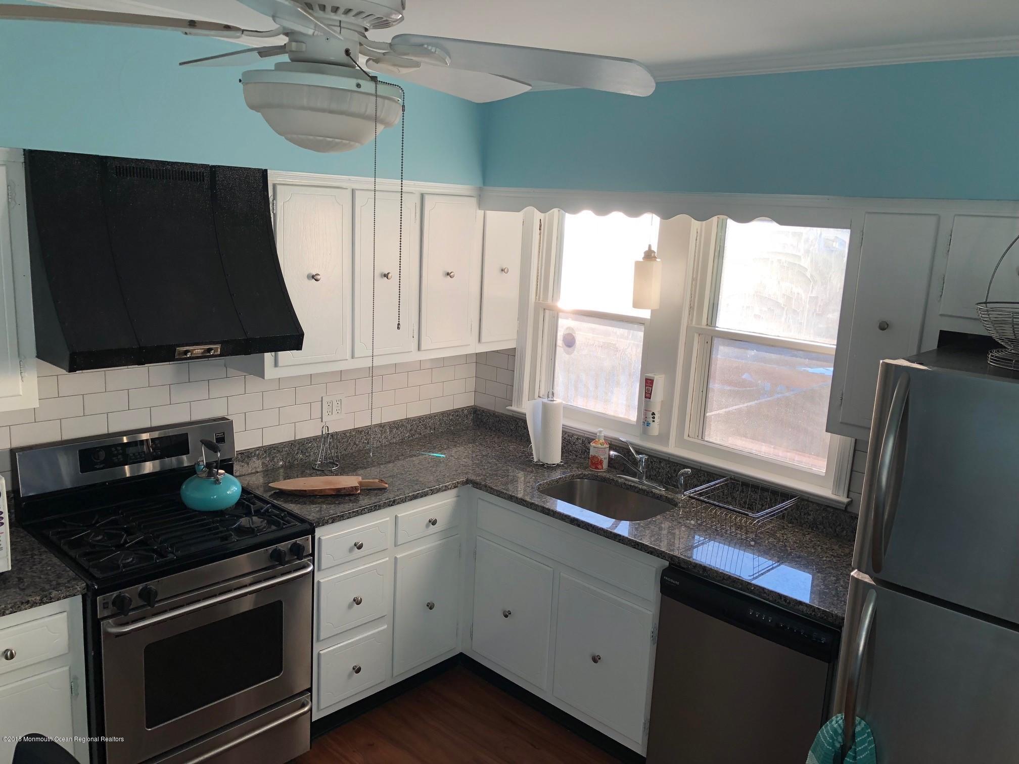 632 Main Avenue, Unit 1 Bay Head, NJ 08742 - Photo 7 of 16 a kitchen with stainless steel appliances a stove a microwave a sink and cabinets