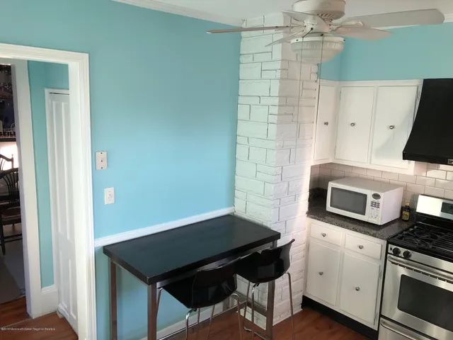 a kitchen with stainless steel appliances a stove a microwave and cabinets