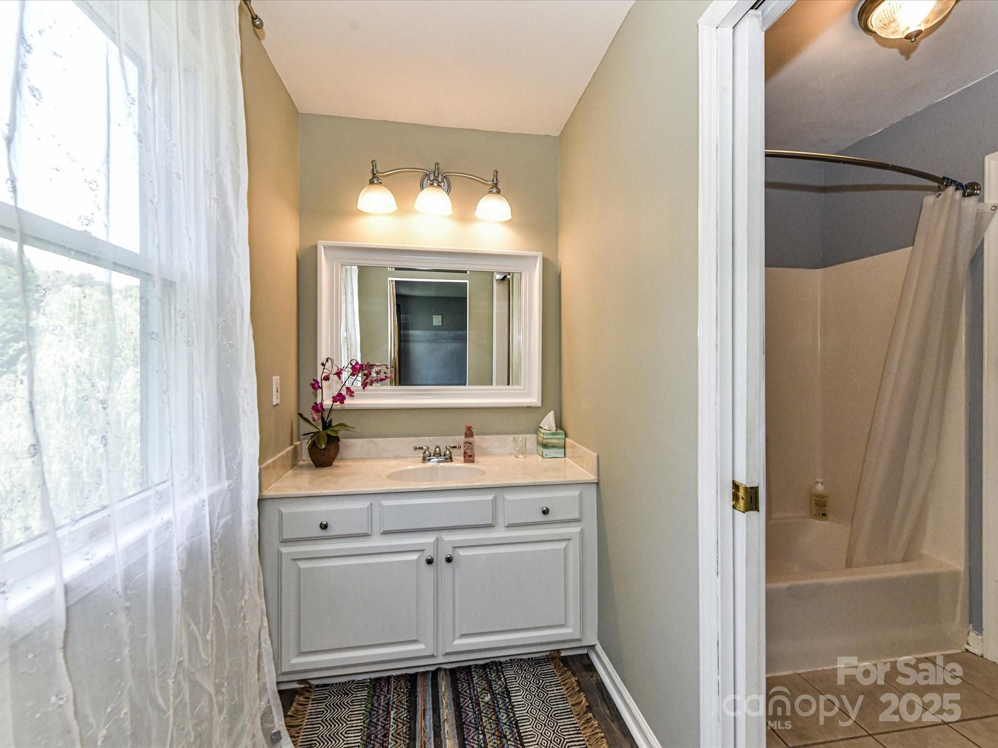 2325 Perry Road Denver, NC 28037 - Photo 29 of 48 a bathroom with a sink mirror and a shower