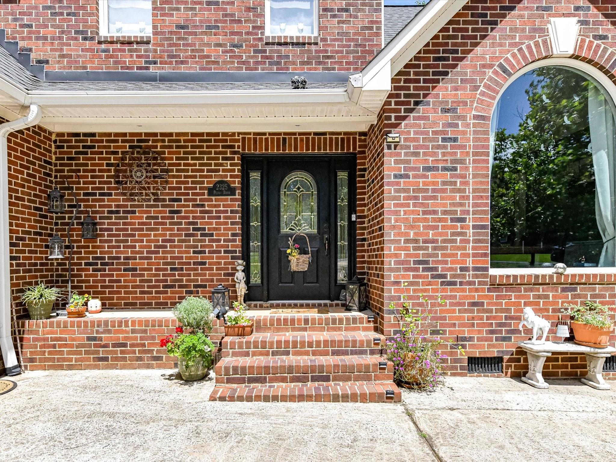 2325 Perry Road Denver, NC 28037 - Photo 4 of 48 a front view of a house with a garden