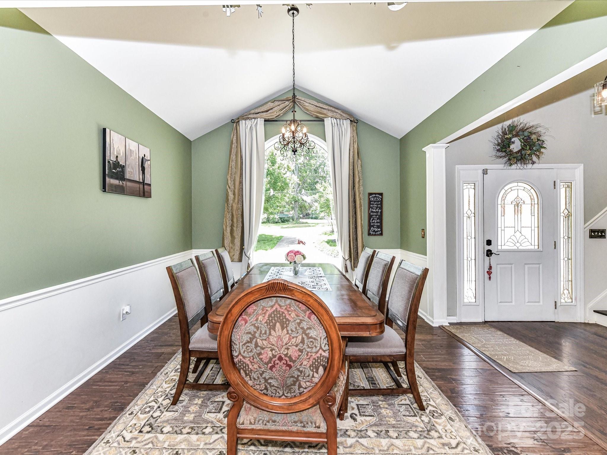 2325 Perry Road Denver, NC 28037 - Photo 9 of 48 a dining room with furniture a chandelier and wooden floor
