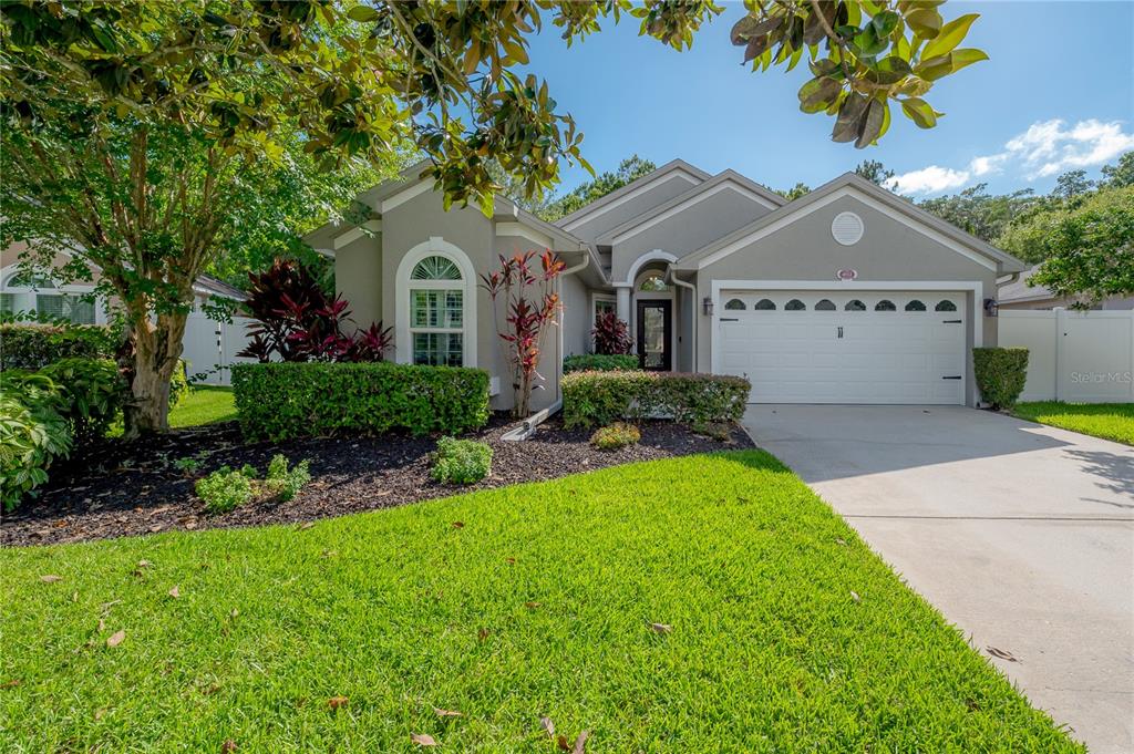 4912 Ridgemoor Circle Palm Harbor, FL 34685 - Photo 1 of 1 a front view of a house with a garden