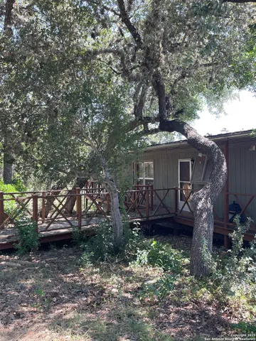 a sign board with tall trees