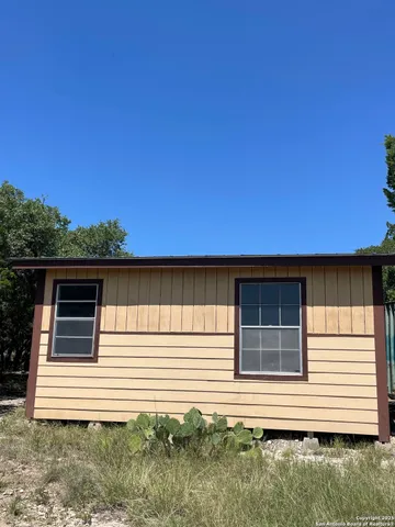 a bathroom with a granite countertop sink and a bathtub