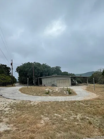 a view of house with outdoor space and car parked