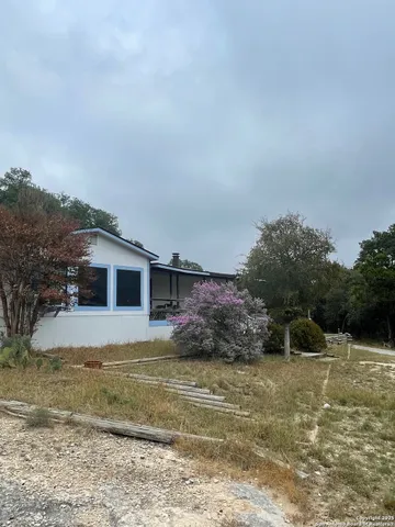 a view of a dirt road with trees in the background