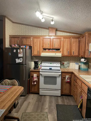 a room with a table chairs and chandelier