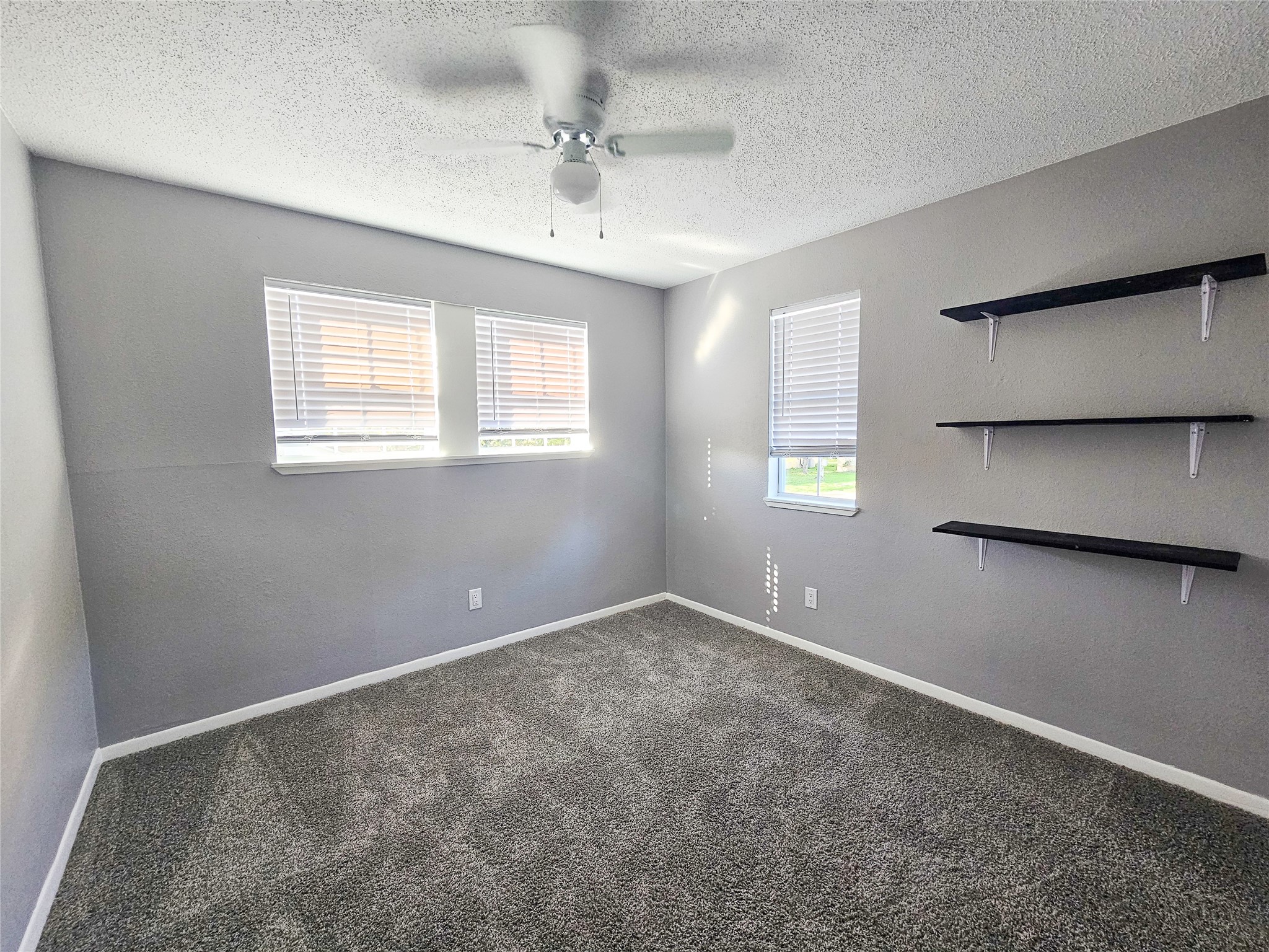 108 Oriole Lane Angleton, TX 77515 - Photo 16 of 20 an empty room with windows and fan