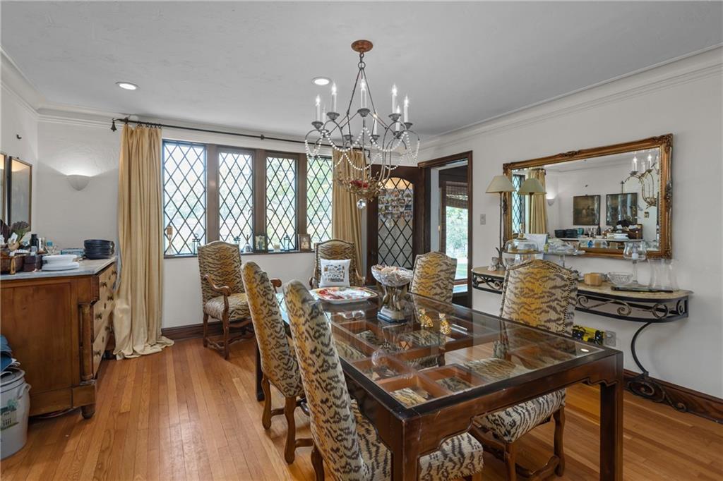 694 Valleyview Road Pittsburgh, PA 15243 - Photo 22 of 50 a view of a dining room with furniture a chandelier and wooden floor