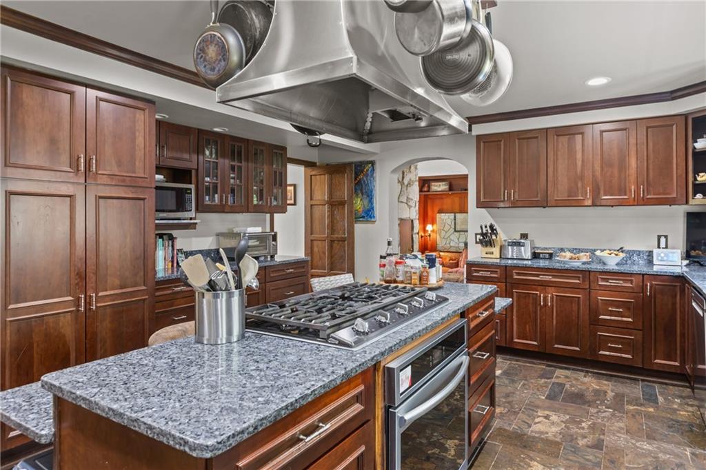 694 Valleyview Road Pittsburgh, PA 15243 - Photo 31 of 50 a kitchen with stainless steel appliances granite countertop a sink a stove and a wooden cabinets