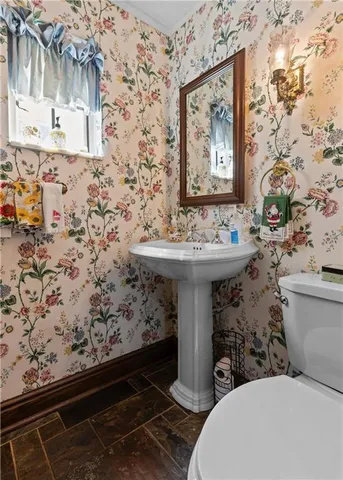 a bathroom with a sink toilet and mirror