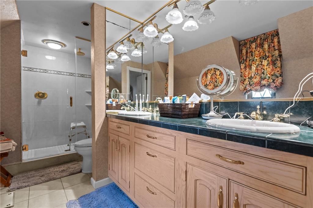 694 Valleyview Road Pittsburgh, PA 15243 - Photo 39 of 50 a bathroom with a sink a mirror and a shower