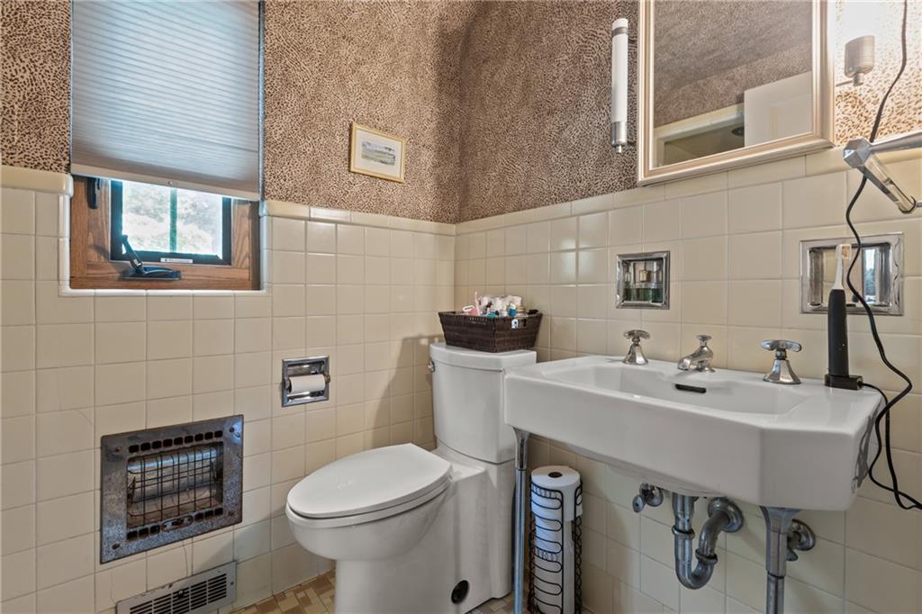 694 Valleyview Road Pittsburgh, PA 15243 - Photo 43 of 50 a bathroom with a sink a toilet and mirror