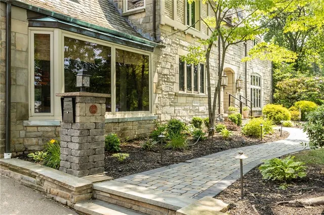 a front view of a house with a garden