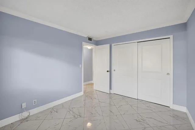 a front view of house and yard with beautiful flowers and green space