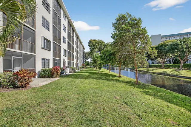 a view of a street with a building and trees in the background