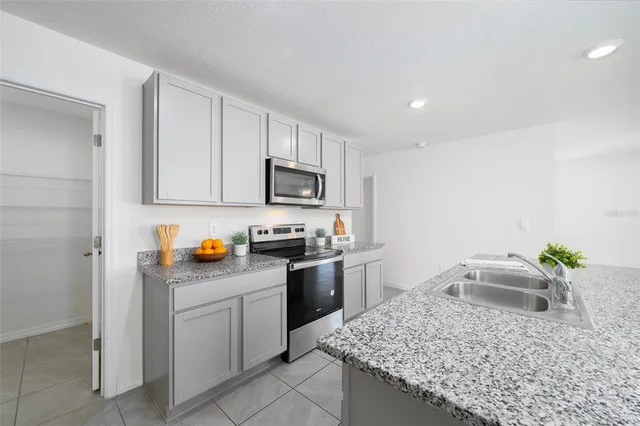 a kitchen with sink cabinets and microwave