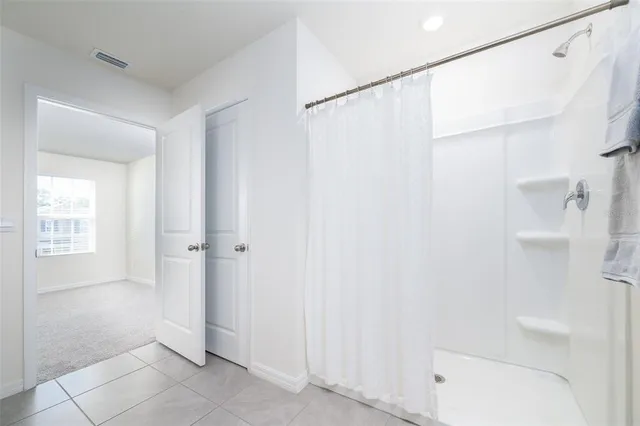 a bathroom with a shower and a tub