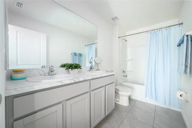 a bathroom with a granite countertop sink a toilet and a bathtub