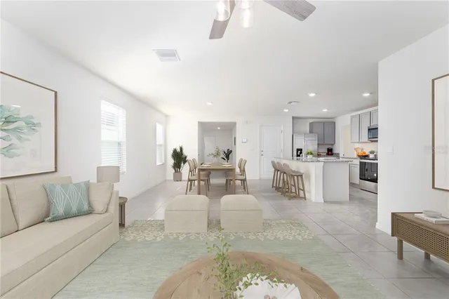 a living room with furniture dining table and kitchen view