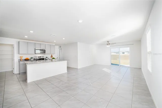 a large white kitchen with a stove a sink and a refrigerator