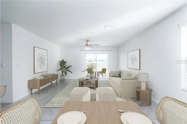 a living room with furniture or couch and a potted plant