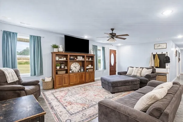a living room with furniture and kitchen view