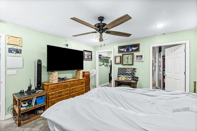 a bedroom with a bed and a flat screen tv