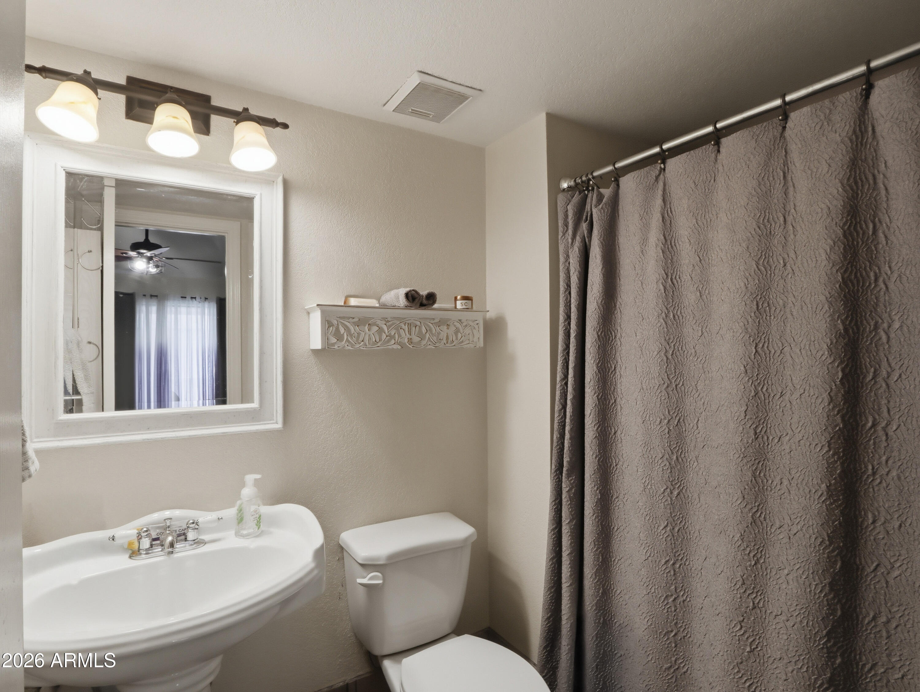 1402 East Osborn Road, Unit 2 Phoenix, AZ 85014 - Photo 15 of 29 a bathroom with a sink mirror and toilet