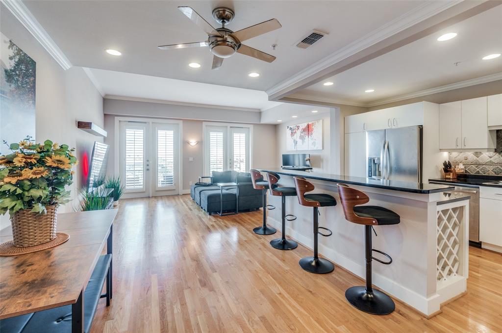 5055 Addison Circle, Unit 707 Addison, TX 75001 - Photo 1 of 1 Open living area with kitchen, breakfast bar and dining area plus light filled living room and large balcony