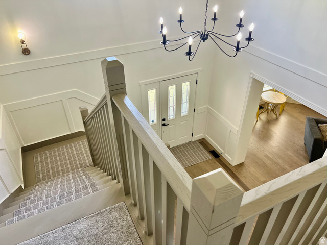 812 East Bates Cyn Road Tooele, UT 84074 - Photo 55 of 144 Entry foyer featuring a white paneled door with glass inserts, a black chandelier, and light wood-finish flooring
