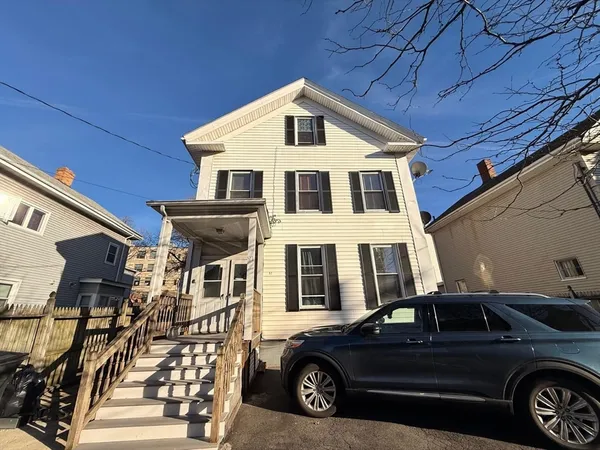 a view of a car parked in front of a house