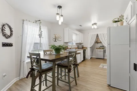 a view of a dining room with furniture and wooden floor