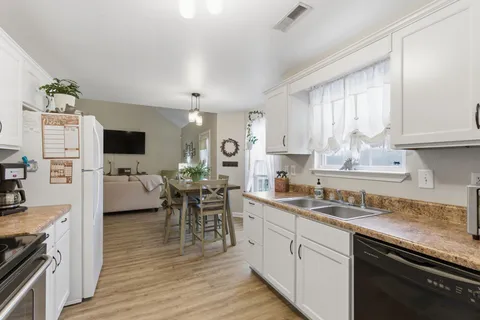 a kitchen with cabinets a sink and appliances