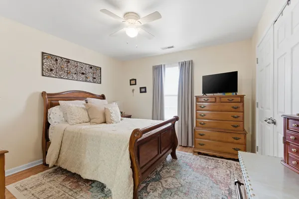 a bedroom with a bed and a television