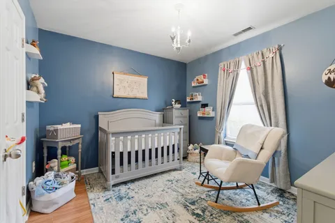 a bedroom with a bed and windows