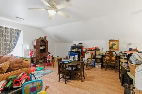 a play room with furniture and a wooden floor