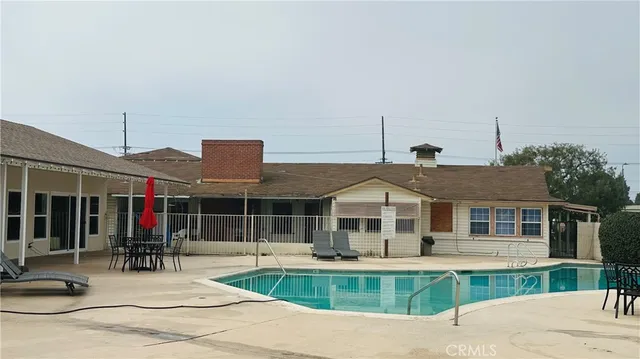 a view of a house with swimming pool and a porch