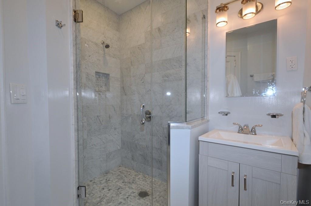69 Harney Road, Unit 3A Scarsdale, NY 10583 - Photo 19 of 22 Fully renovated bath with marble tiled step-in shower.