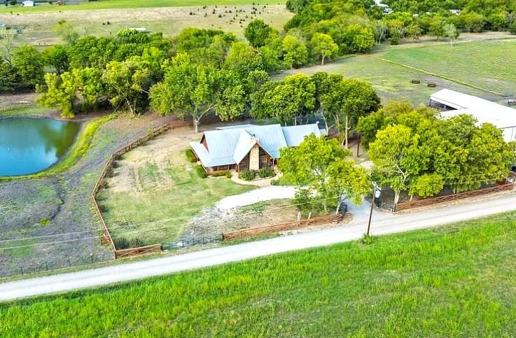 783 County Road 4420 Whitewright, TX 75491 - Photo 1 of 40 a view of a garden with a bench in the garden